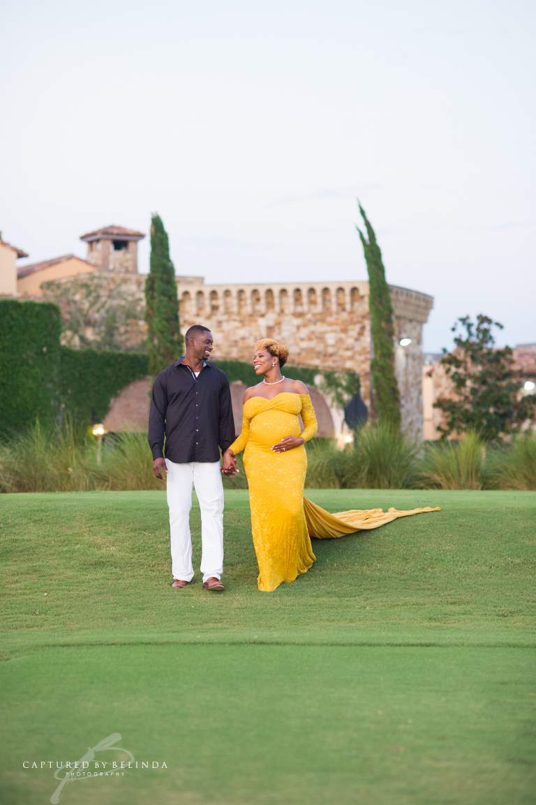 mama and daddy to be walking happily at their Bella Collina Maternity Session
