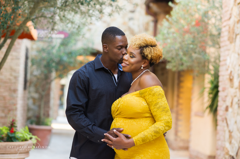 Xan kissing Deidra holding her tummy at Bella Collina