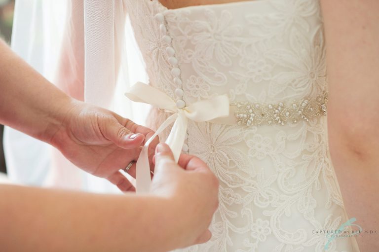 bride getting into her dress 